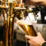 "Dogs and people enjoying craft beer at Paws On Tap's outdoor dog-friendly seating in Whitestown"